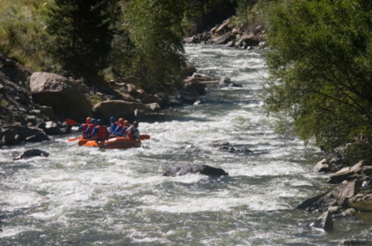 Whitewater rafters negotiate some rough Colorado waters.
